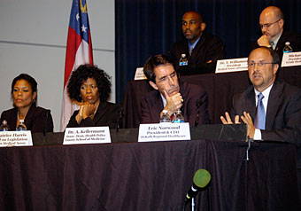 Panel at a town hall meeting, including Emory professor Art Kellermann