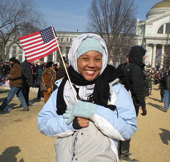 Taharee Jackson standing on the Mall in Washington holding an American flag