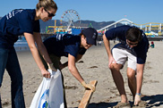 Los Angeles alumni clean up the beach during Emory Cares