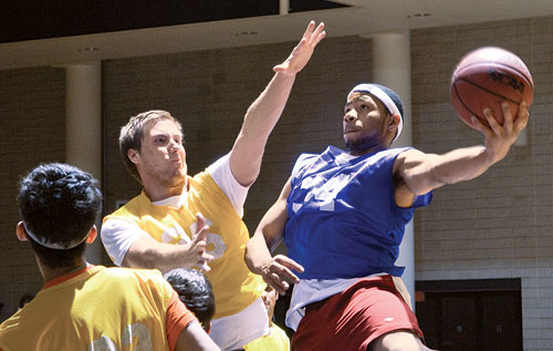 Students playing basketball in the WoodPEC