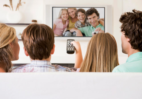 Family watching themselves on TV