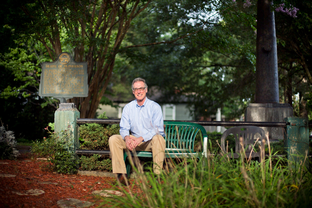 Photo of Daniel Pollock sitting on a bench