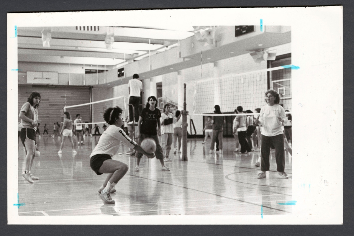 an old photo of diverse students playing volleyball