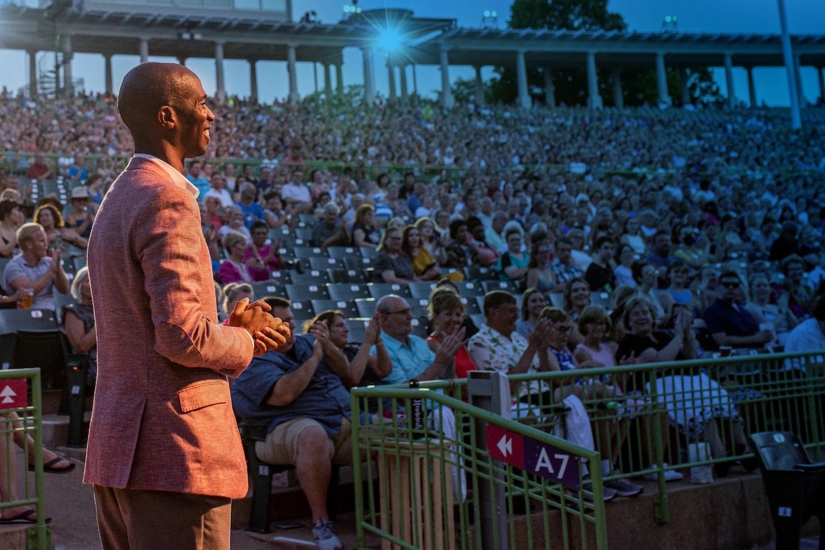 photo of Emory alumnus Kwofe Coleman on stage of The Muny outdoor theater in St. Louis